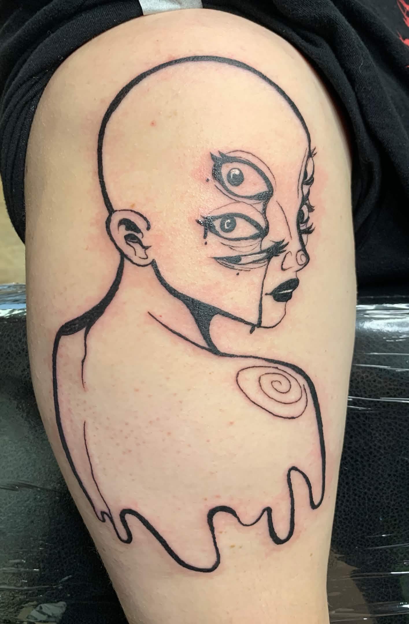 tattoo of the bust of a pretty bald woman with six eyes